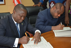 Finance Minister Hon Samuel D Tweah Jr and Mr Orison M Amu Country Manager of the Country Office of the African Development signs 10M as Budget S