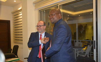 Hon. A. J.Flomo Deputy Minister for Economic Management in a handshake with Director General of the AFD Mr. Remy Rioux